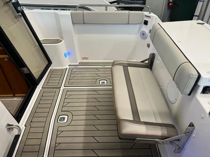  Yacht Photos Pics 2022 Cutwater C-24 Coupe interior with foldable seating and modern flooring.