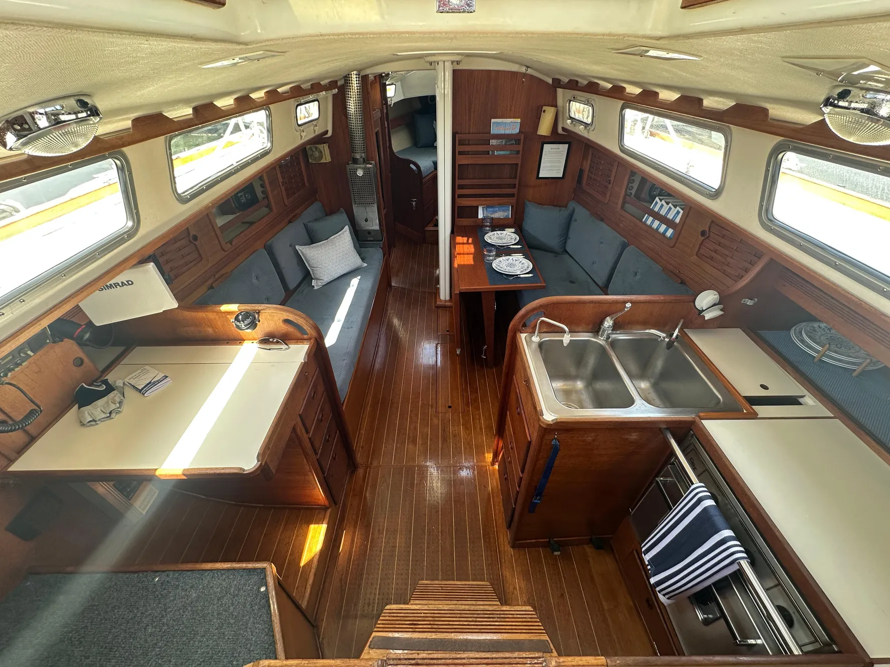 Interior of 1985 Sabre 34 MKI sailboat with wood finish and cozy seating area.