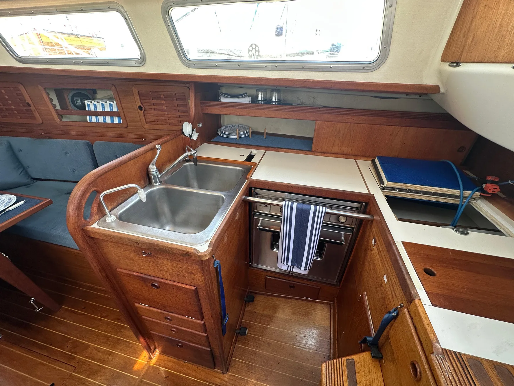 1985 Sabre 34 MKI yacht interior with wooden cabinetry and dual sink.