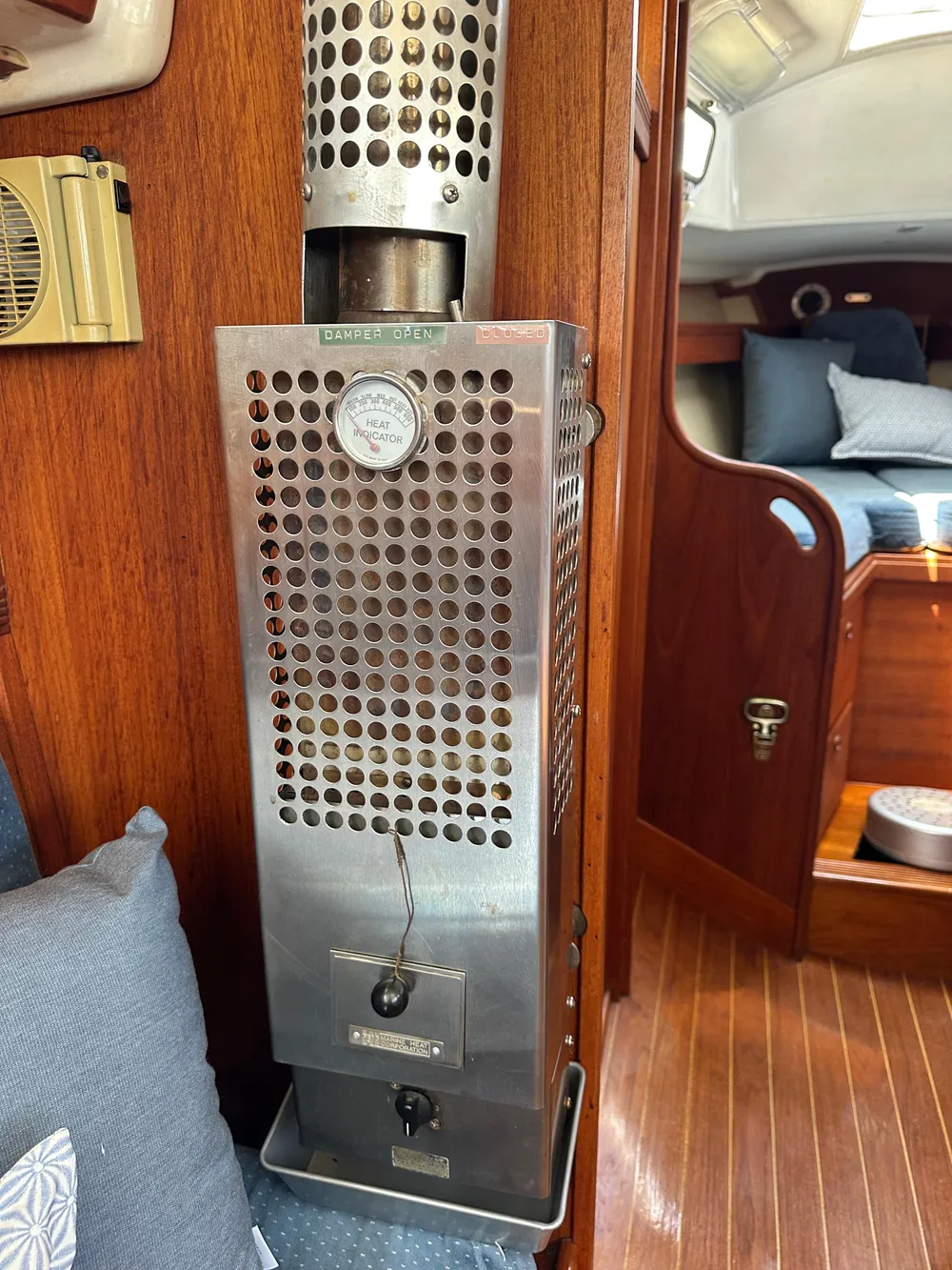 1985 Sabre 34 MKI cabin interior with a stainless steel heater and wooden paneling.