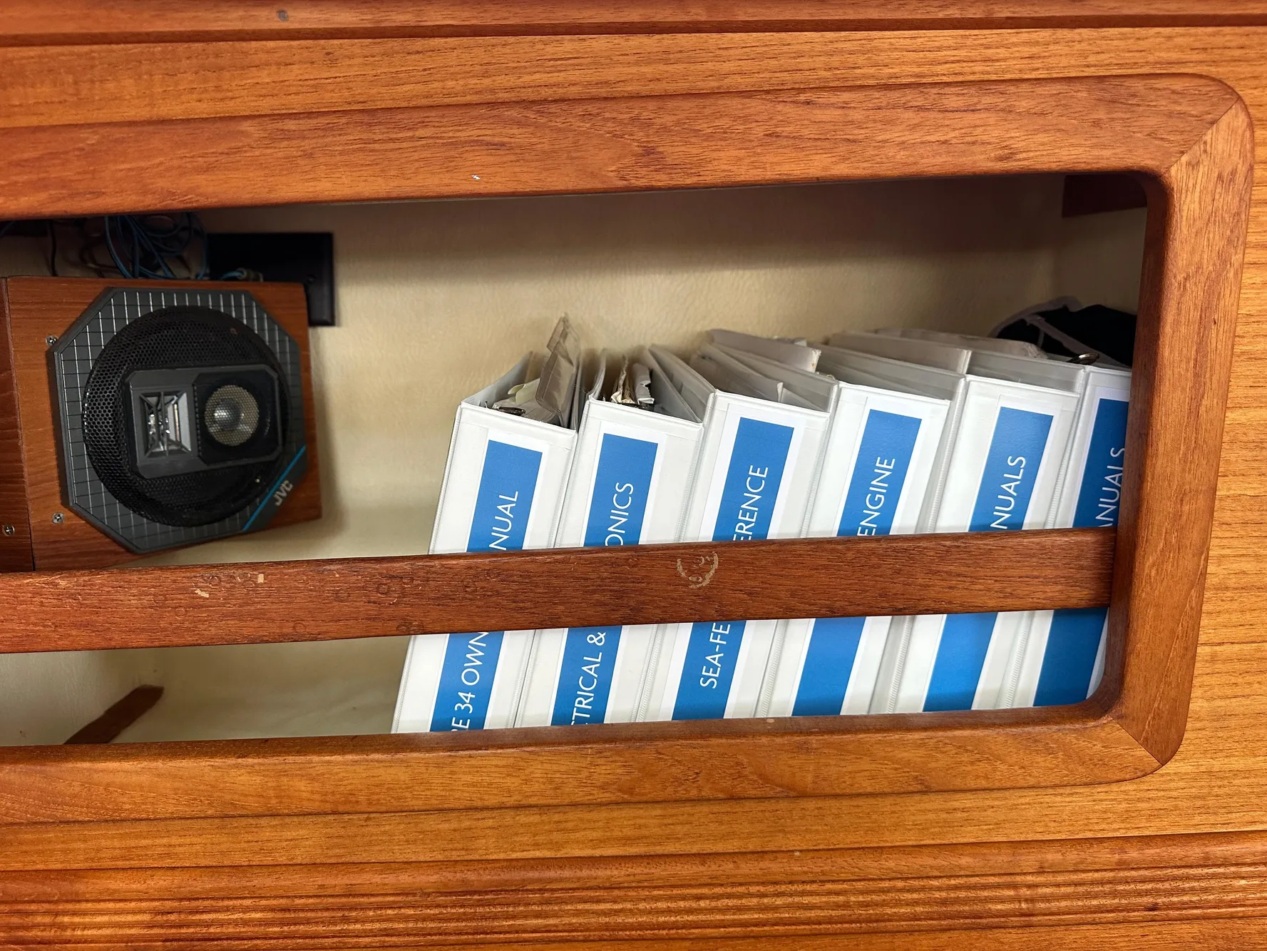 Wooden shelf with manuals and a speaker on a 1985 Sabre 34 MKI yacht.