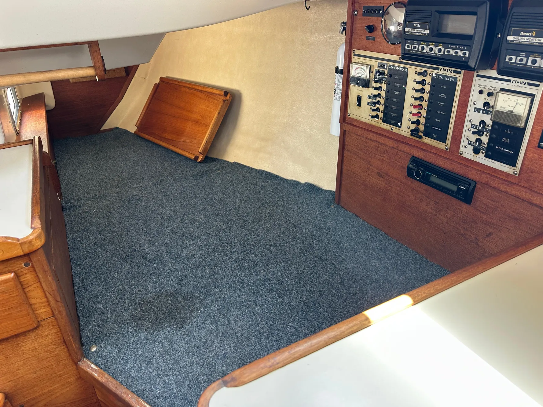 Interior of 1985 Sabre 34 MKI sailboat with control panel and carpeted flooring.
