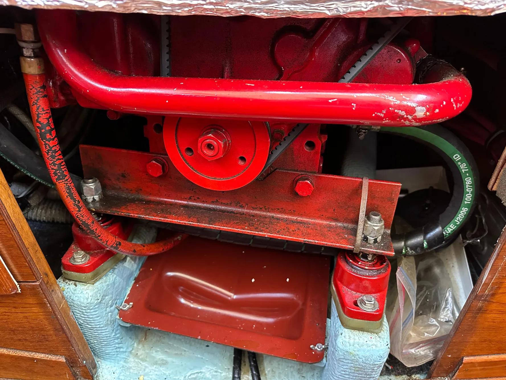 Engine compartment of a 1985 Sabre 34 MKI sailboat, featuring red mechanical components.