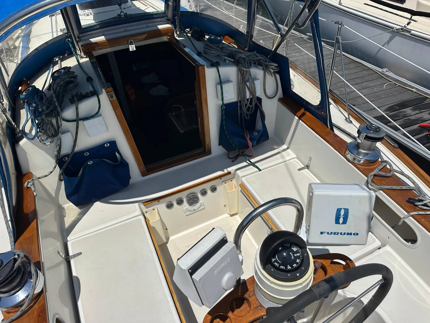 Cockpit of 1985 Sabre 34 MKI sailboat with navigation equipment and steering wheel.