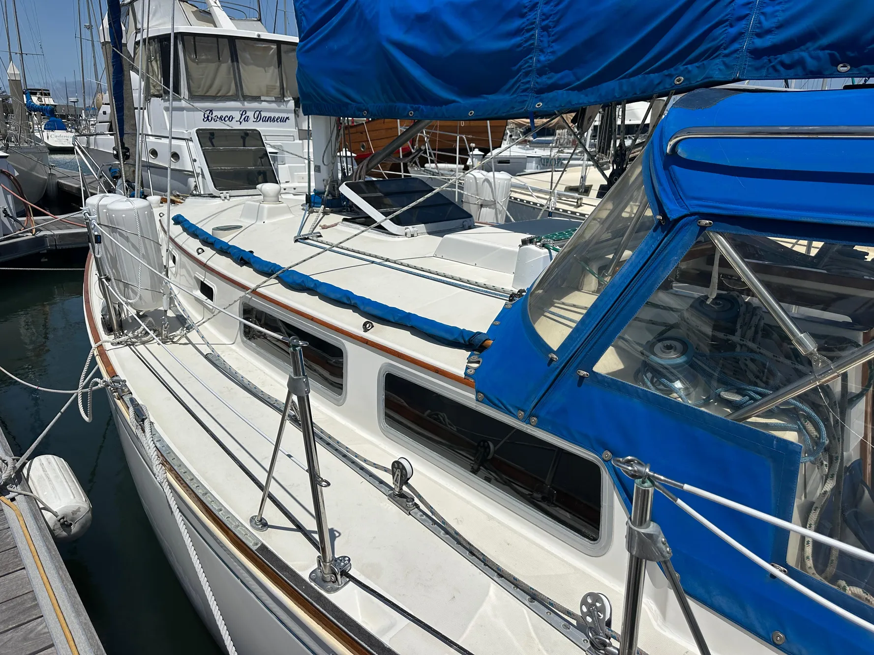 1985 Sabre 34 MKI sailboat docked, featuring blue canvas covers and sleek design.
