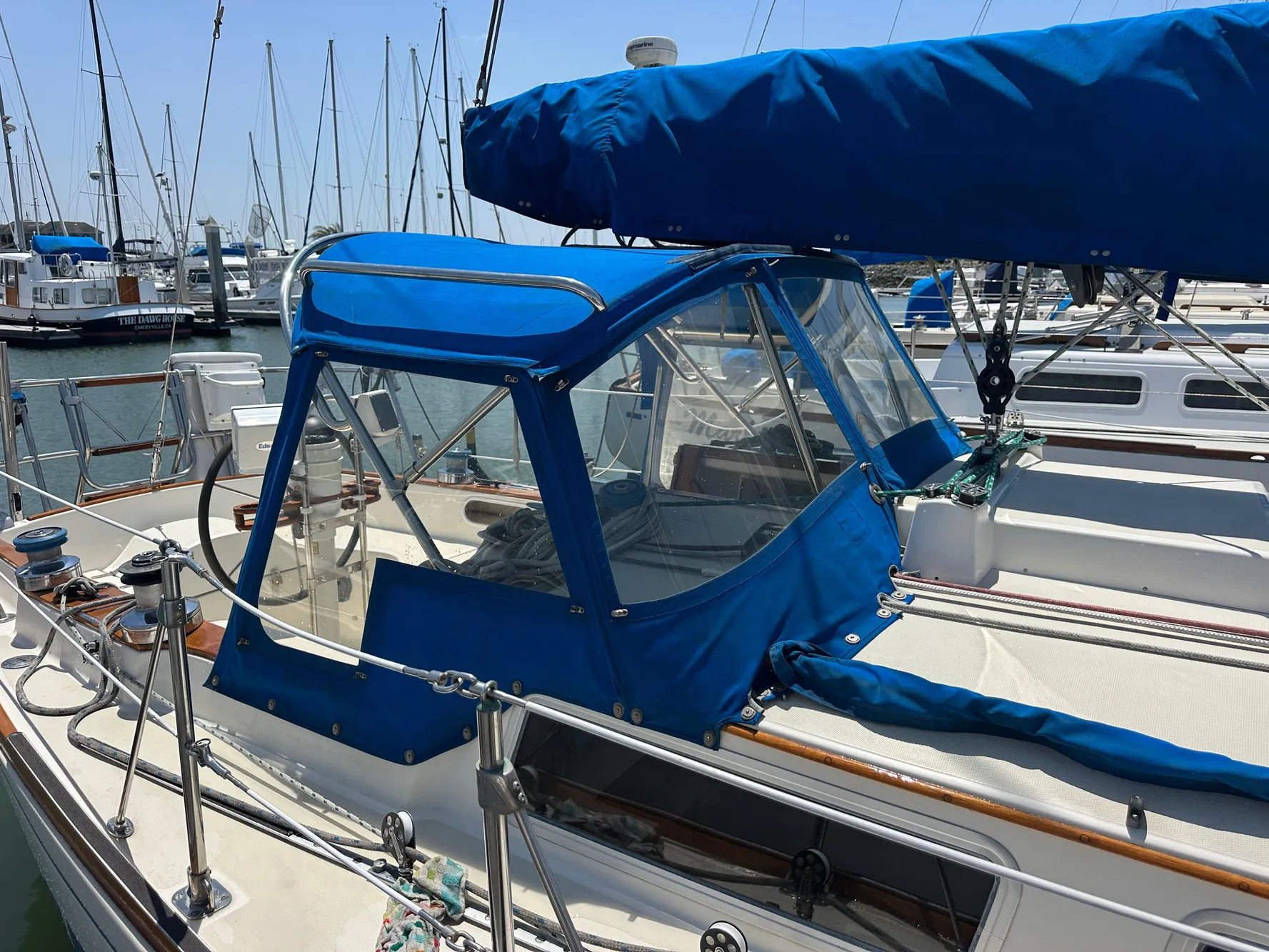 1985 Sabre 34 MKI sailboat with blue canvas cover docked at marina.