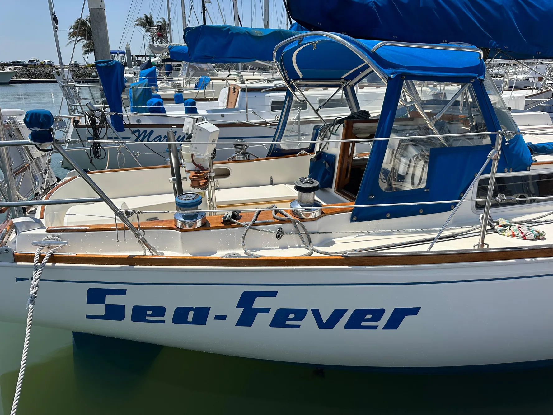 1985 Sabre 34 MKI sailboat "Sea-Fever" docked in a marina with blue covers.