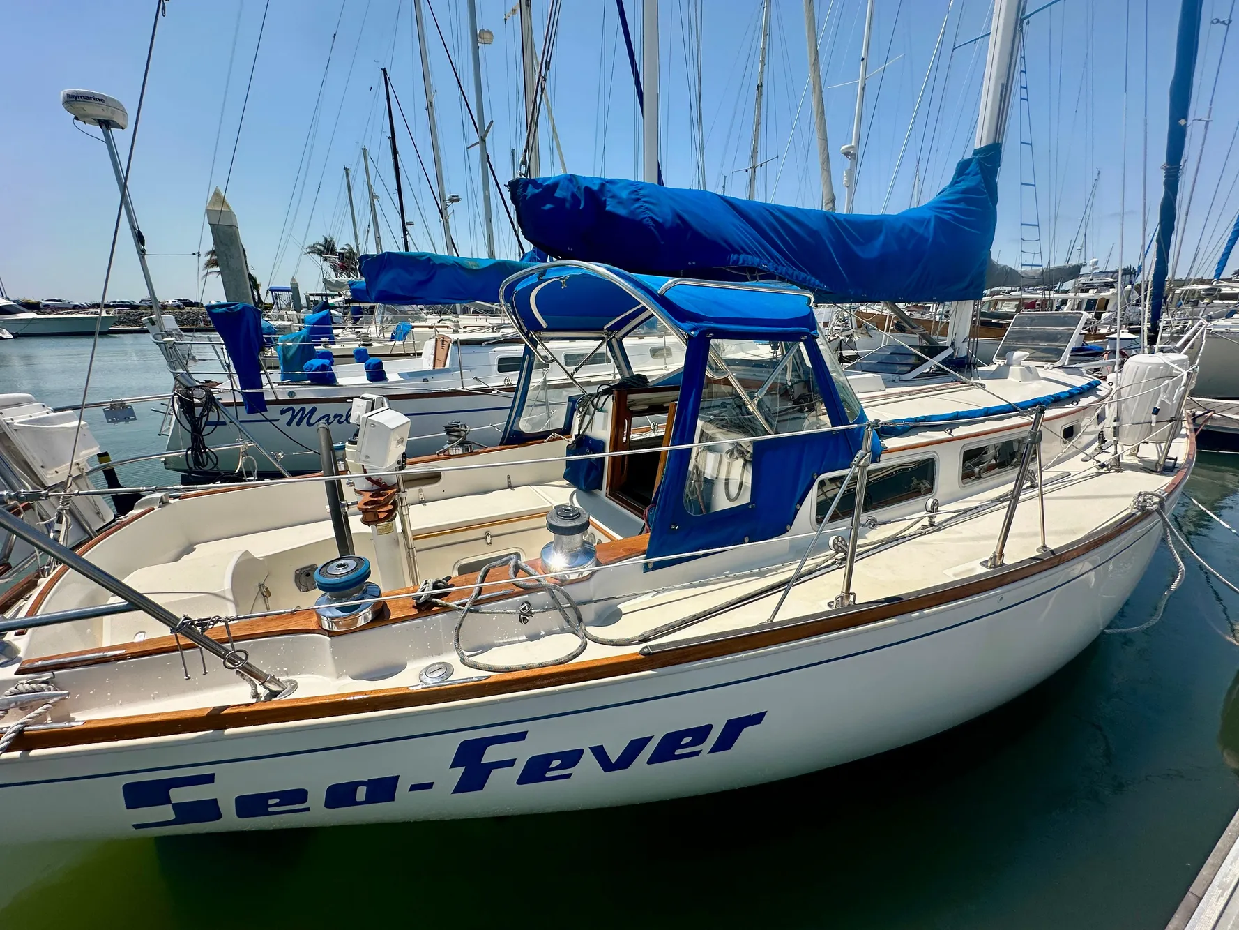 1985 Sabre 34 MKI sailboat "Sea-Fever" docked in a marina, featuring blue covers.