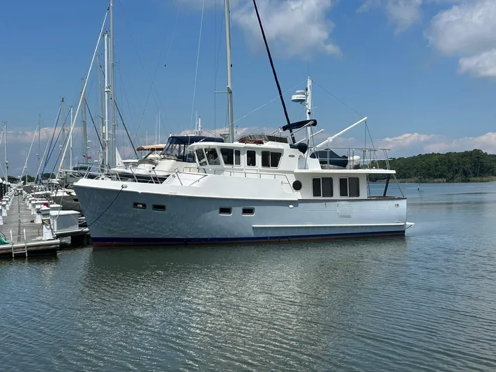 Duet Yacht Photos Pics Selene 43 yacht from 1999 docked in a marina under a clear blue sky.