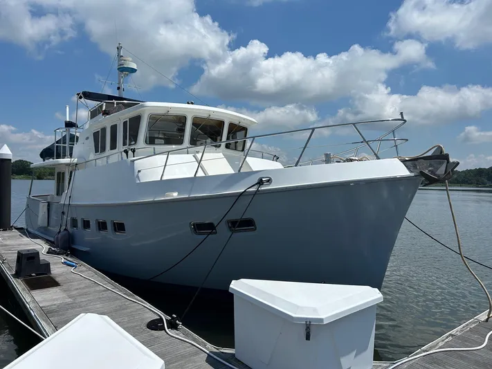 Duet Yacht Photos Pics Selene 43 yacht from 1999 docked under a blue sky with clouds.