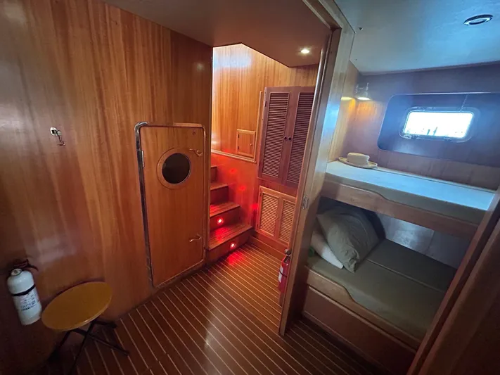 Duet Yacht Photos Pics Cozy wooden interior of 1999 Selene 43 yacht with bunk beds and ambient lighting.