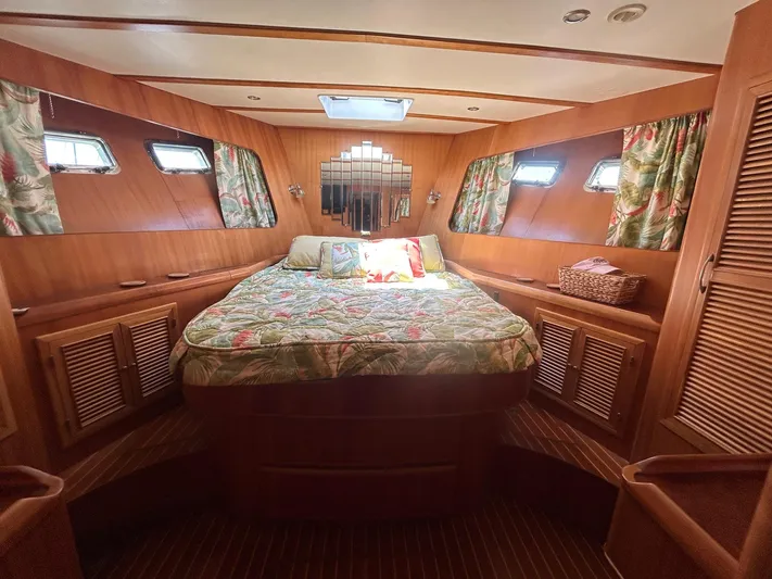 Duet Yacht Photos Pics Luxurious cabin interior of a 1999 Selene 43 yacht with cozy bedding and wooden finishes.