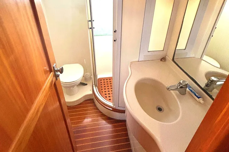 Duet Yacht Photos Pics Bathroom interior of 1999 Selene 43 yacht with shower, sink, and toilet.