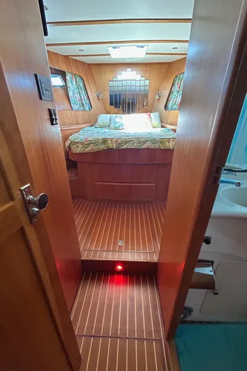 Duet Yacht Photos Pics Cozy cabin interior of 1999 Selene 43 yacht with wood paneling and bed.