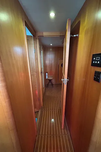 Duet Yacht Photos Pics Wood-paneled hallway inside 1999 Selene 43 yacht, featuring polished flooring and modern lighting.
