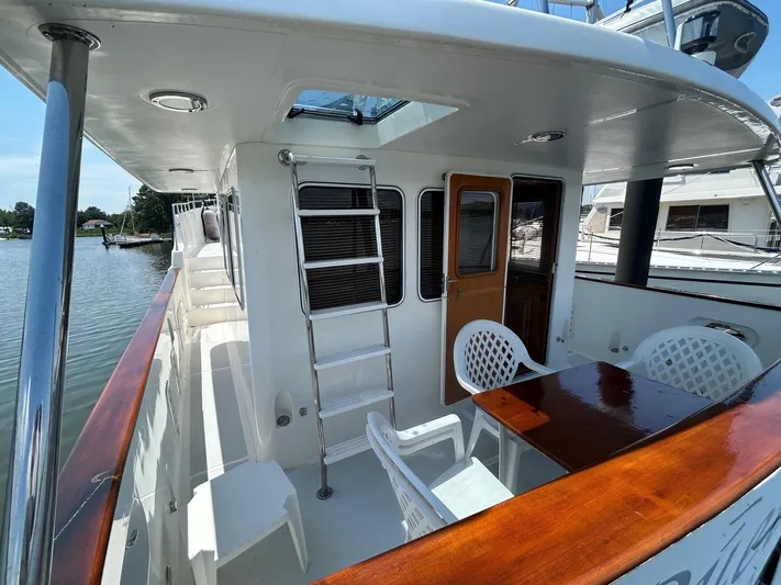 Duet Yacht Photos Pics Selene 43 yacht deck with seating, table, and ladder, 1999 model.