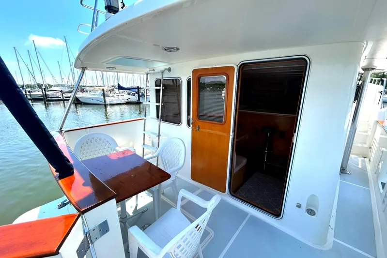 Duet Yacht Photos Pics Selene 43 yacht deck, 1999 model, featuring seating area and marina view.