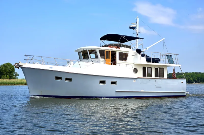 Duet Yacht Photos Pics Selene 43 yacht from 1999 cruising on a calm waterway under a clear blue sky.