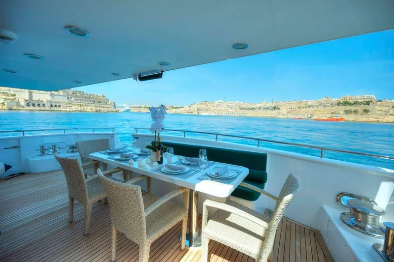 Voyager Yacht Photos Pics Luxury dining setup on 2004 Algar Explorer yacht with scenic waterfront view.