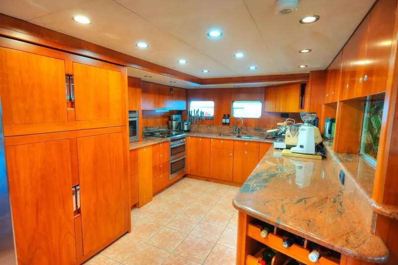 Voyager Yacht Photos Pics Luxurious 2004 Algar Explorer yacht kitchen with wooden cabinetry and modern appliances.