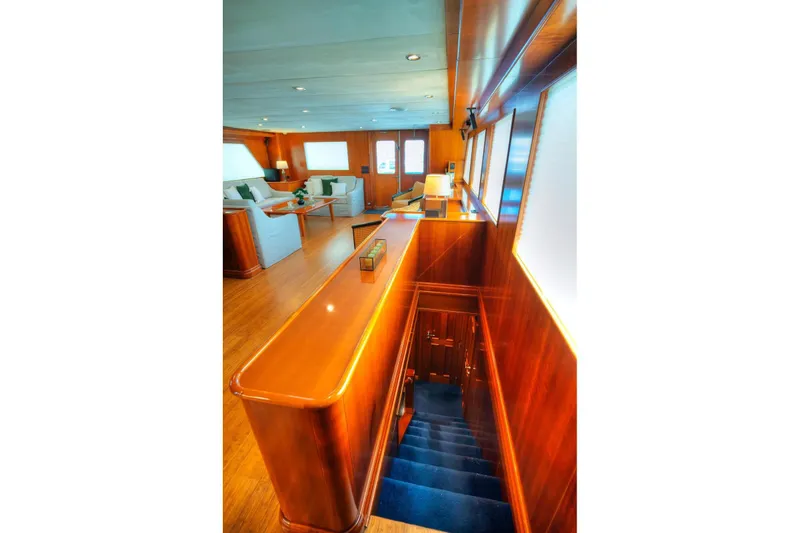 Voyager Yacht Photos Pics Luxurious interior of 2004 Algar Explorer yacht with wooden finishes and elegant seating area.