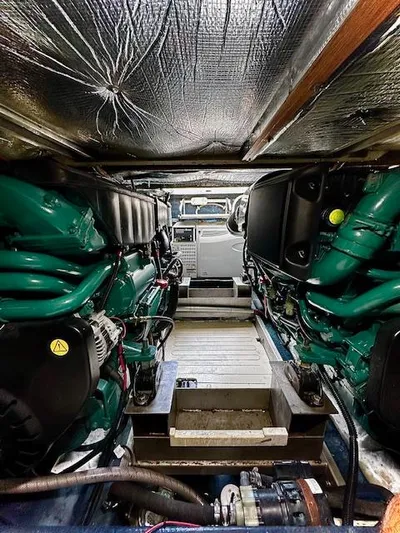 L Altro G Yacht Photos Pics Engine room of 2006 Cranchi Atlantique 48 yacht, showcasing dual engines and mechanical components.