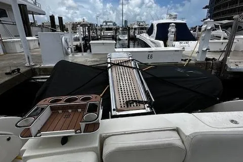 L Altro G Yacht Photos Pics 2006 Cranchi Atlantique 48 yacht docked at marina with covered deck and cup holders.