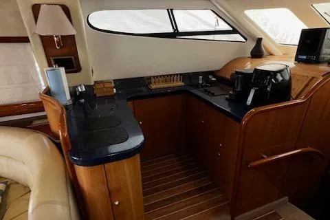 L Altro G Yacht Photos Pics 2006 Cranchi Atlantique 48 yacht interior with wooden cabinetry and modern appliances.