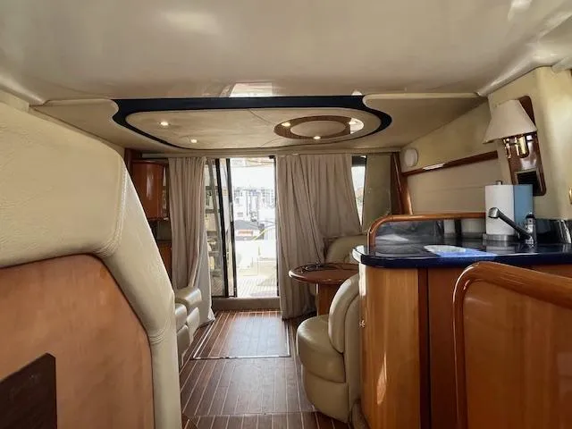 L Altro G Yacht Photos Pics Luxurious interior of 2006 Cranchi Atlantique 48 yacht with elegant wood finishes.