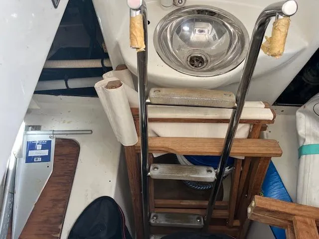 L Altro G Yacht Photos Pics Interior view of a 2006 Cranchi Atlantique 48 yacht, featuring a compact sink and ladder.