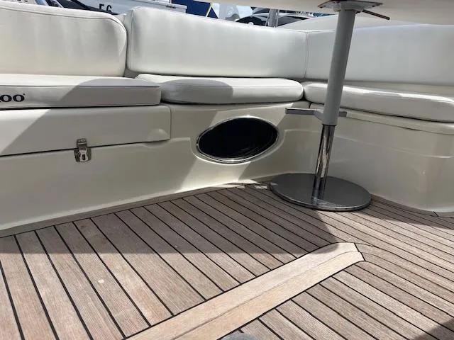 L Altro G Yacht Photos Pics 2006 Cranchi Atlantique 48 yacht interior with white seating and wooden flooring.