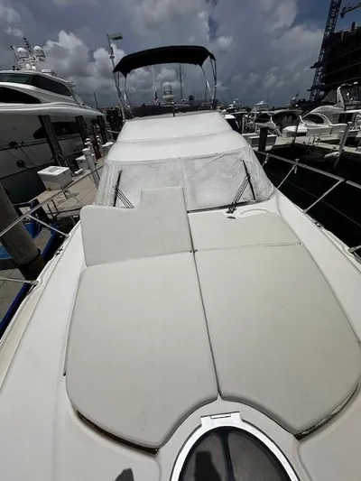 L Altro G Yacht Photos Pics 2006 Cranchi Atlantique 48 yacht with sunbathing deck, docked at marina under cloudy sky.