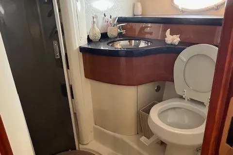 L Altro G Yacht Photos Pics Bathroom interior of 2006 Cranchi Atlantique 48 yacht, featuring sink and toilet.