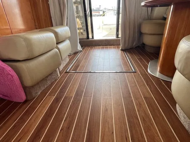 L Altro G Yacht Photos Pics Luxurious interior of 2006 Cranchi Atlantique 48 yacht with wooden flooring and leather seating.