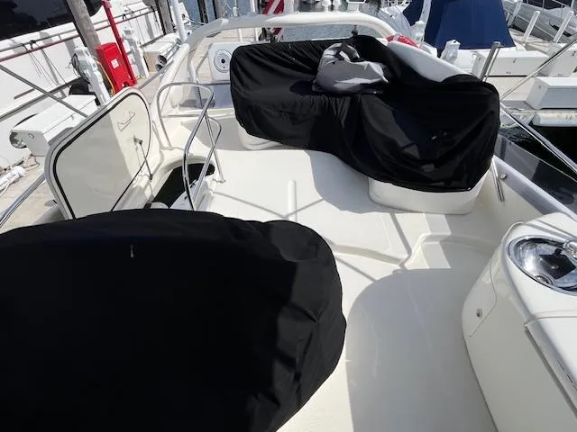 L Altro G Yacht Photos Pics 2006 Cranchi Atlantique 48 yacht deck with covered seating and railing.