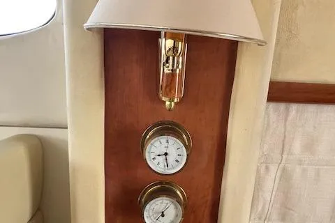 L Altro G Yacht Photos Pics Wall-mounted lamp and gauges inside 2006 Cranchi Atlantique 48 yacht cabin.