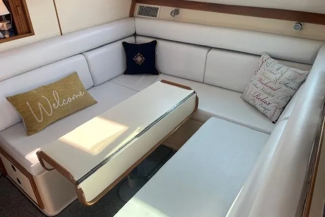  Yacht Photos Pics Interior of 2002 Albin 32 + 2 Command Bridge with white seating and decorative pillows.