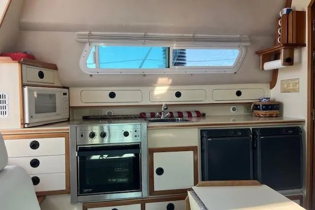  Yacht Photos Pics Interior of 2002 Albin 32 + 2 Command Bridge with kitchen appliances and storage.