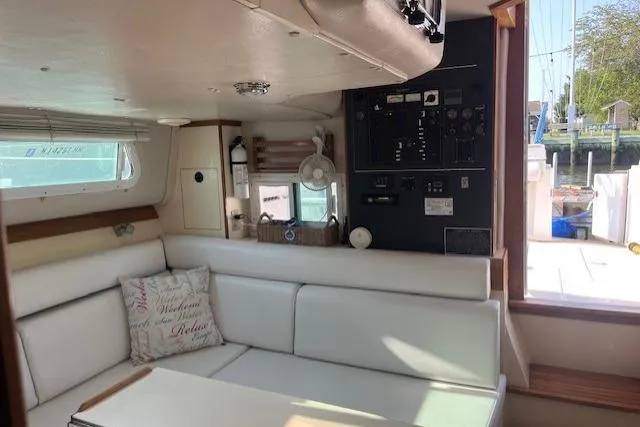  Yacht Photos Pics Interior of 2002 Albin 32 + 2 Command Bridge with white seating and control panel.