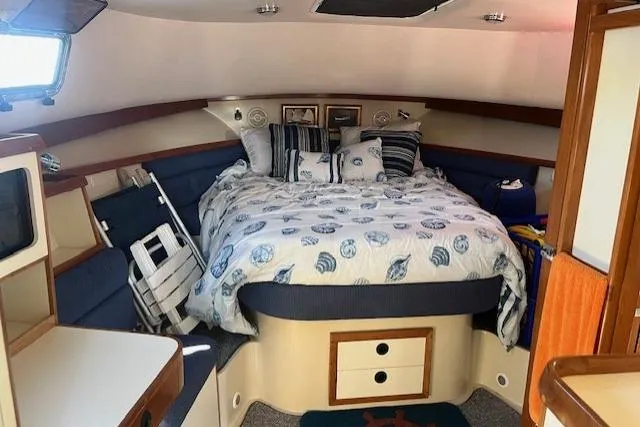  Yacht Photos Pics Cozy cabin interior of 2002 Albin 32 + 2 Command Bridge with nautical-themed bedding.