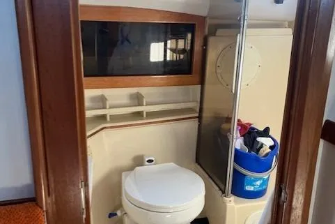  Yacht Photos Pics 2002 Albin 32 + 2 Command Bridge bathroom with toilet and storage area.