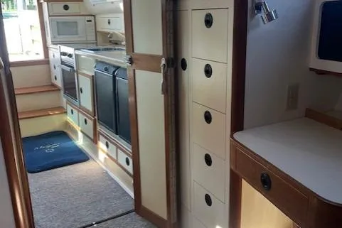  Yacht Photos Pics Interior of 2002 Albin 32 + 2 Command Bridge, featuring kitchen and storage cabinets.