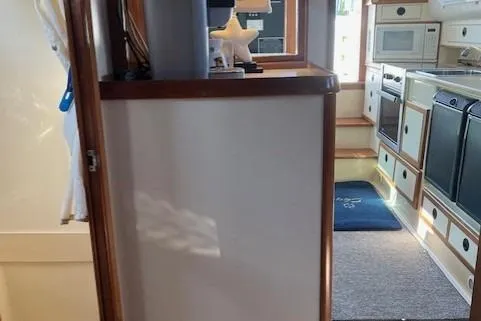  Yacht Photos Pics Interior of 2002 Albin 32 + 2 Command Bridge, featuring kitchen and stairs.