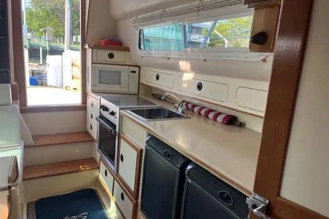  Yacht Photos Pics 2002 Albin 32 + 2 Command Bridge kitchen with stove, microwave, and sink.