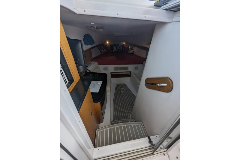 'why Knot' Yacht Photos Pics 2008 Donzi 38 ZSF cabin interior with bed, kitchenette, and wooden accents.