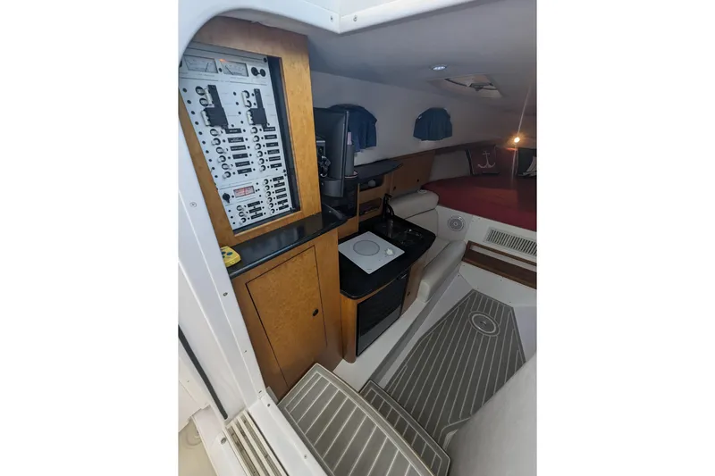 'why Knot' Yacht Photos Pics 2008 Donzi 38 ZSF cabin interior with control panel, kitchenette, and sleeping area.