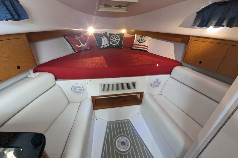 'why Knot' Yacht Photos Pics 2008 Donzi 38 ZSF cabin interior with red bedding and nautical-themed pillows.
