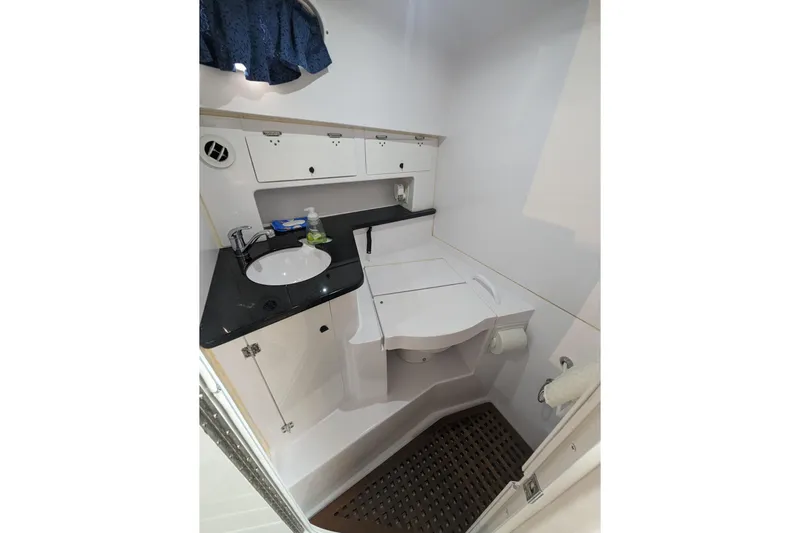 'why Knot' Yacht Photos Pics 2008 Donzi 38 ZSF boat bathroom with sink, storage cabinets, and compact design.