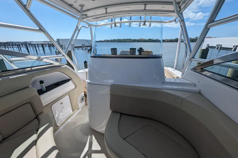 'why Knot' Yacht Photos Pics 2008 Donzi 38 ZSF boat interior with seating, overlooking a serene waterfront.