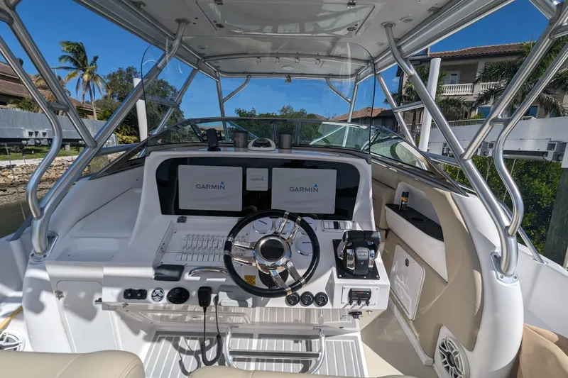 'why Knot' Yacht Photos Pics 2008 Donzi 38 ZSF boat cockpit with Garmin navigation system and steering wheel.